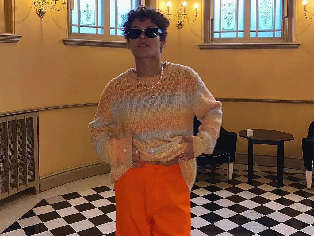 Omar Rudberg matches the background of his walls with his orange fit.