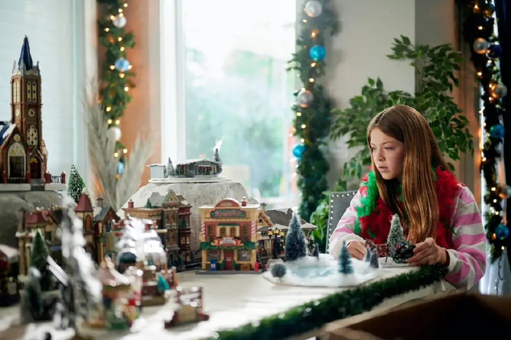 Chloe ( Maesa Nicholson) playing with her magical Christmas village