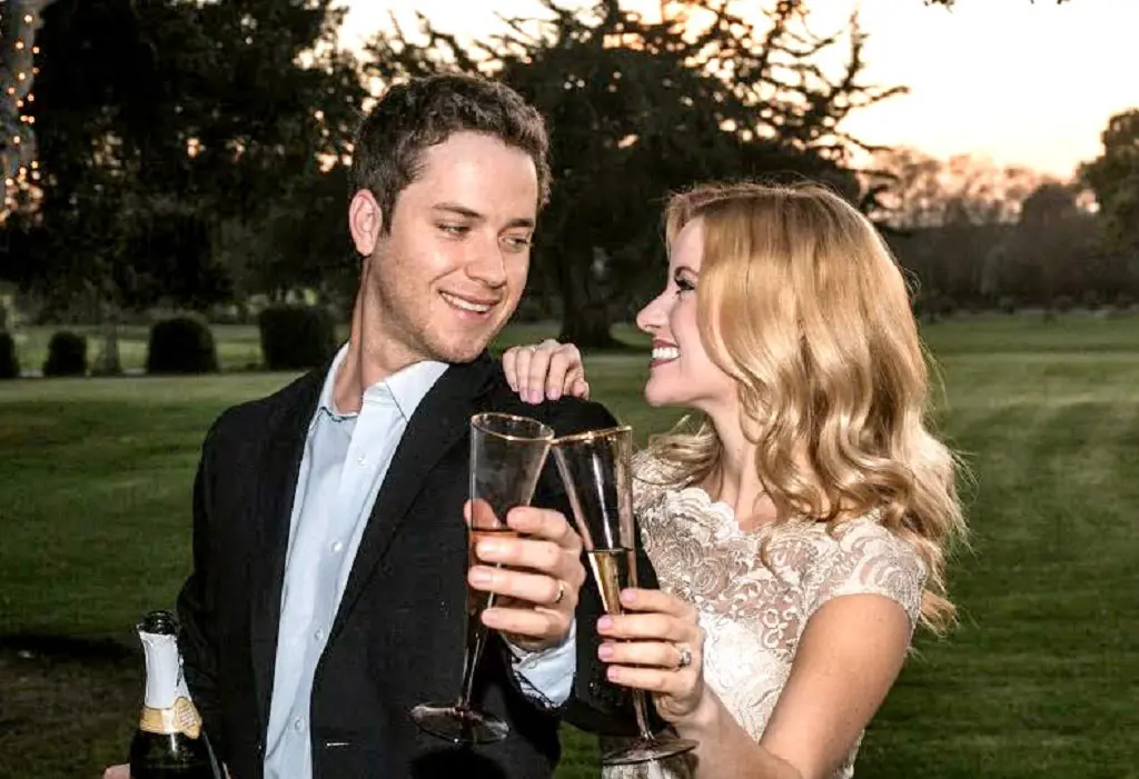 The bride and groom-to-be shared a toast with golden champagne glasses from BHLDN