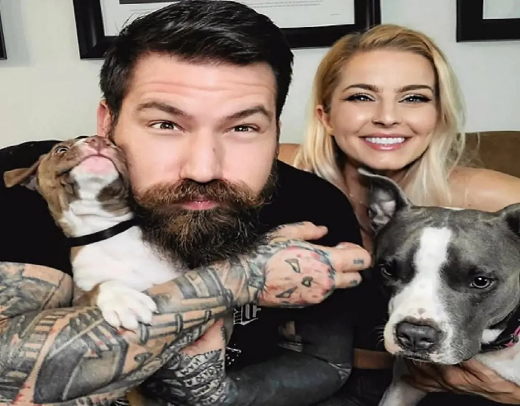 Leah and Aaron with their two pit bull dogs. 