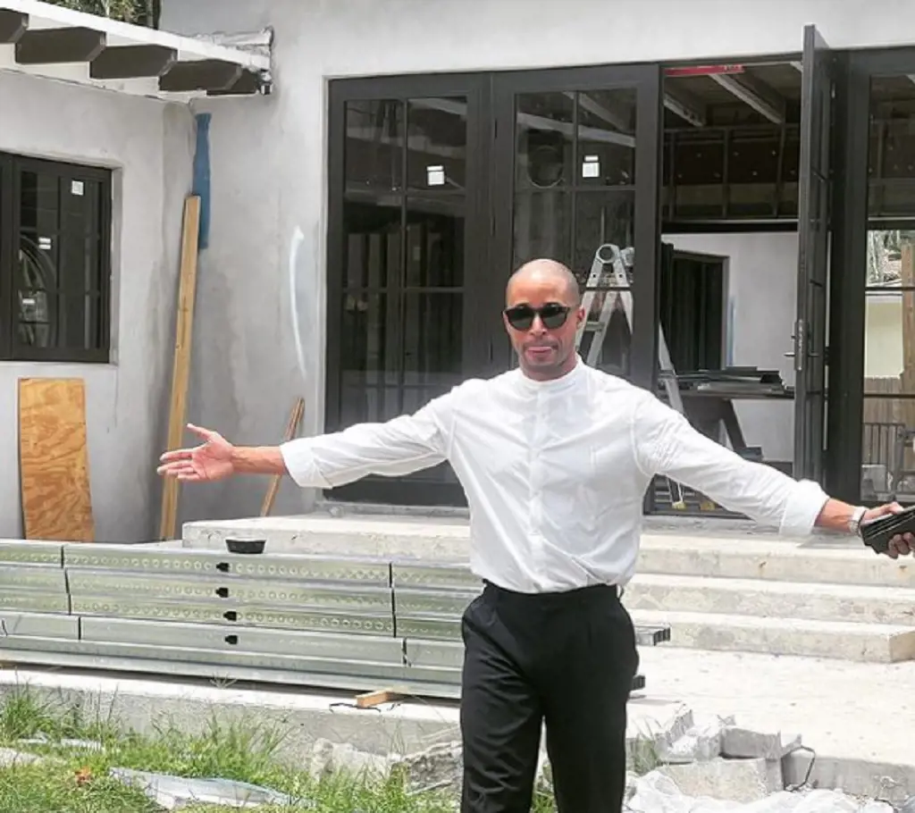 Ray in front of his newly built house