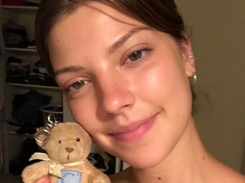 Catherine Missal holding a doll on one of her Instagram posts.