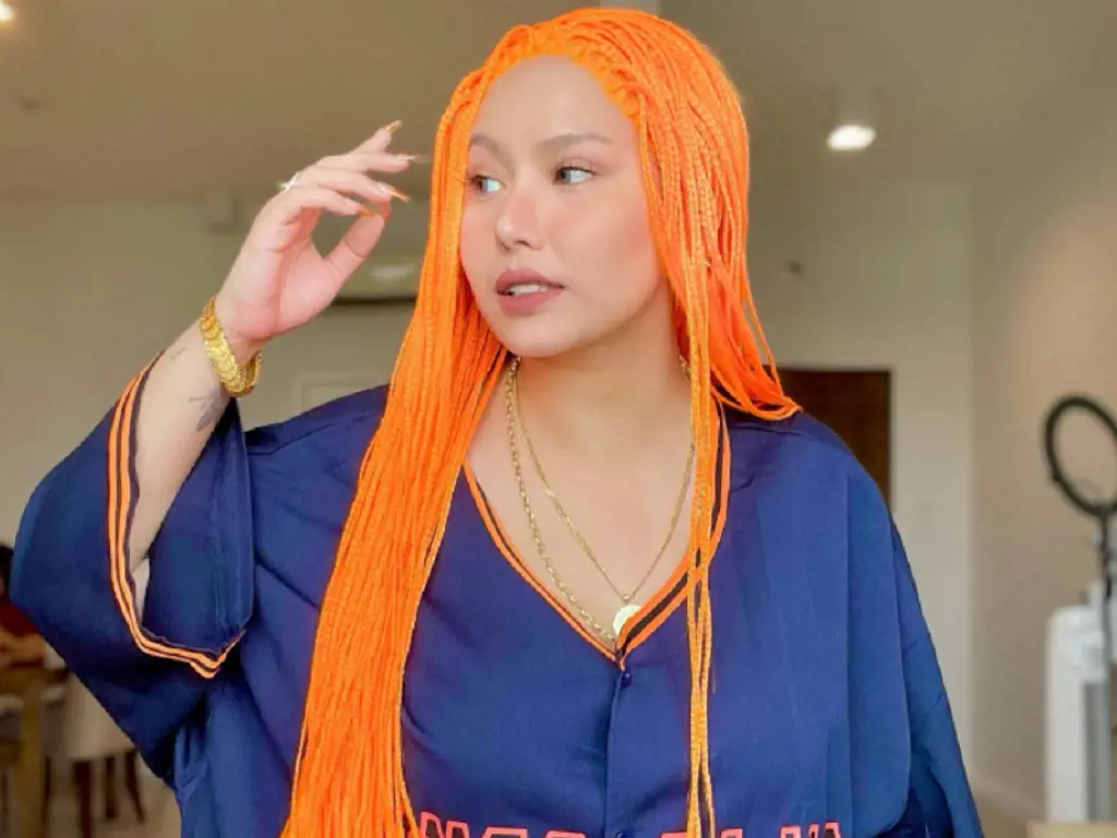 Toni Fowler posing after coloring orange in her hair