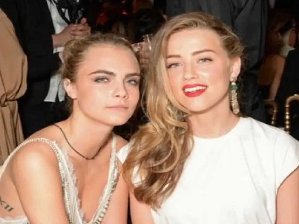 Amber Heard and Cara Delevingne are in the picture. I think there is also a video of them together with Elon Musk.