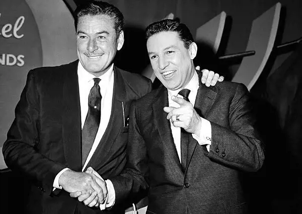 Mike Wallace, right, poses for a photograph with actor Errol Flynn before an episode of NBC's 