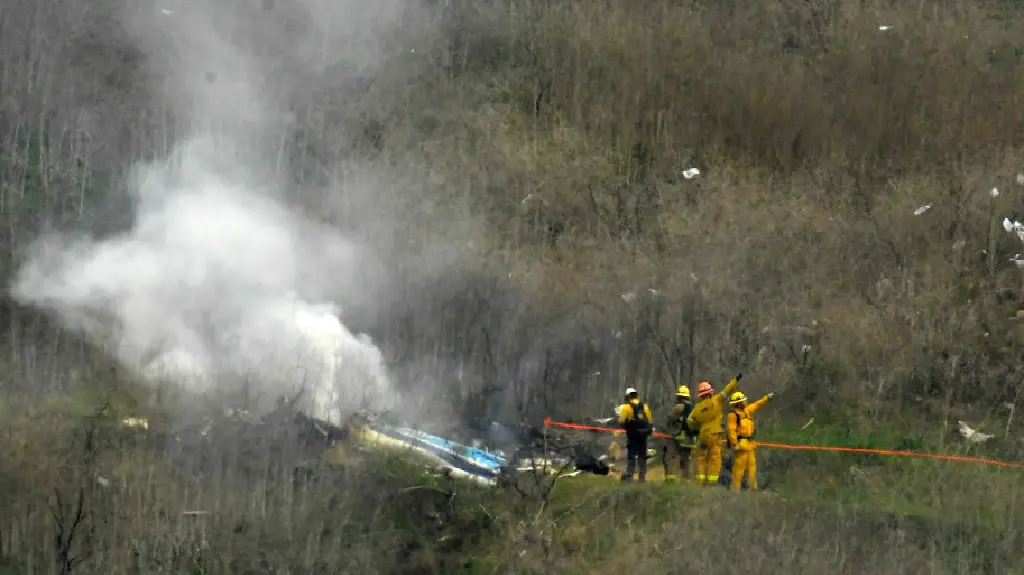 In Calabasas, California, on January 26, 2020, firefighters attend to the aftermath of a helicopter crash that claimed the life of former NBA basketball player Kobe Bryant. The Los Angeles County Sheriff's Department is being sued by Bryant's wife.