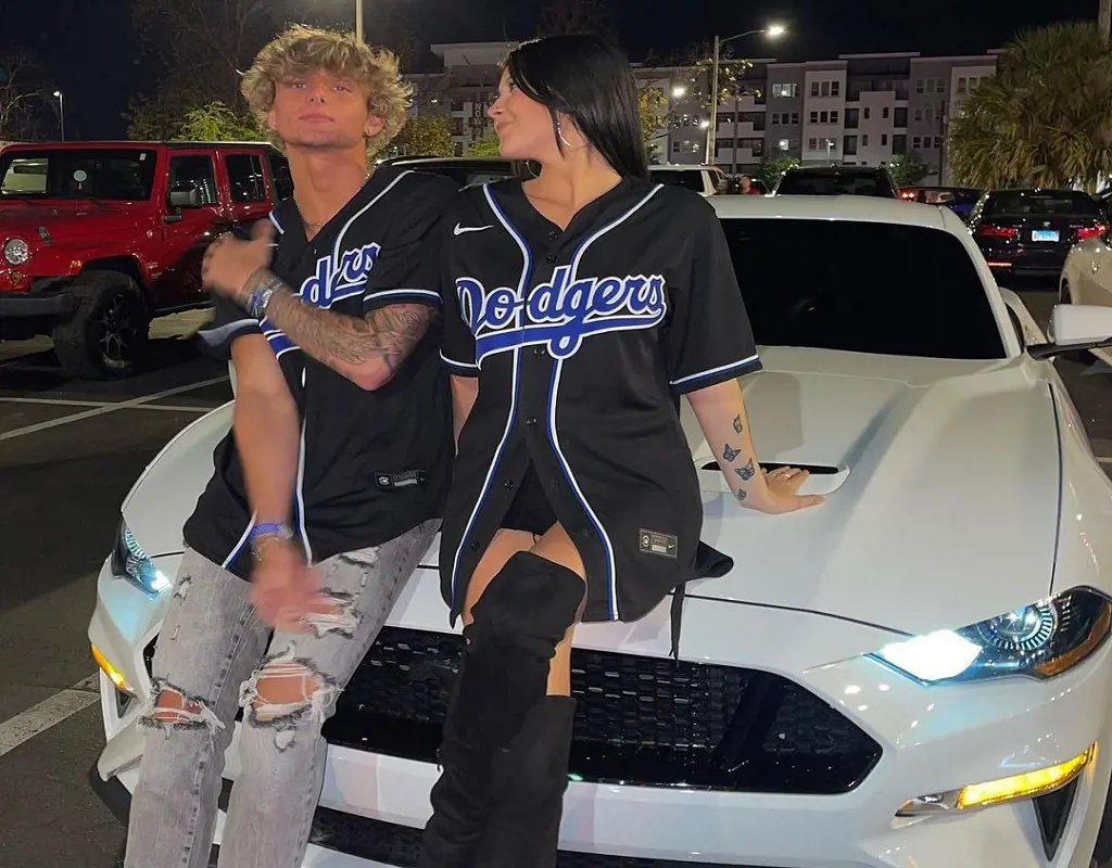 Christen Whitman with her boyfriend Rocky Yarbrough posing infront of the car