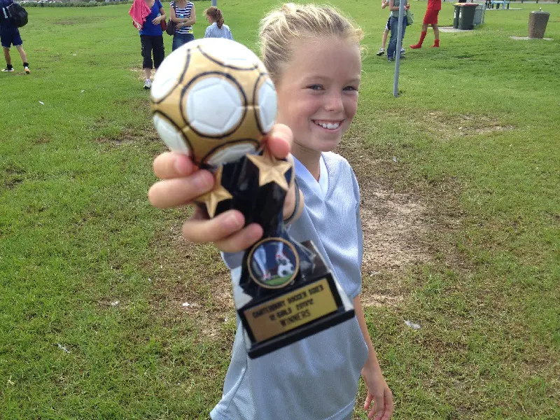 Milly posted a picture of winning a football trophy in her Facebook wall.
