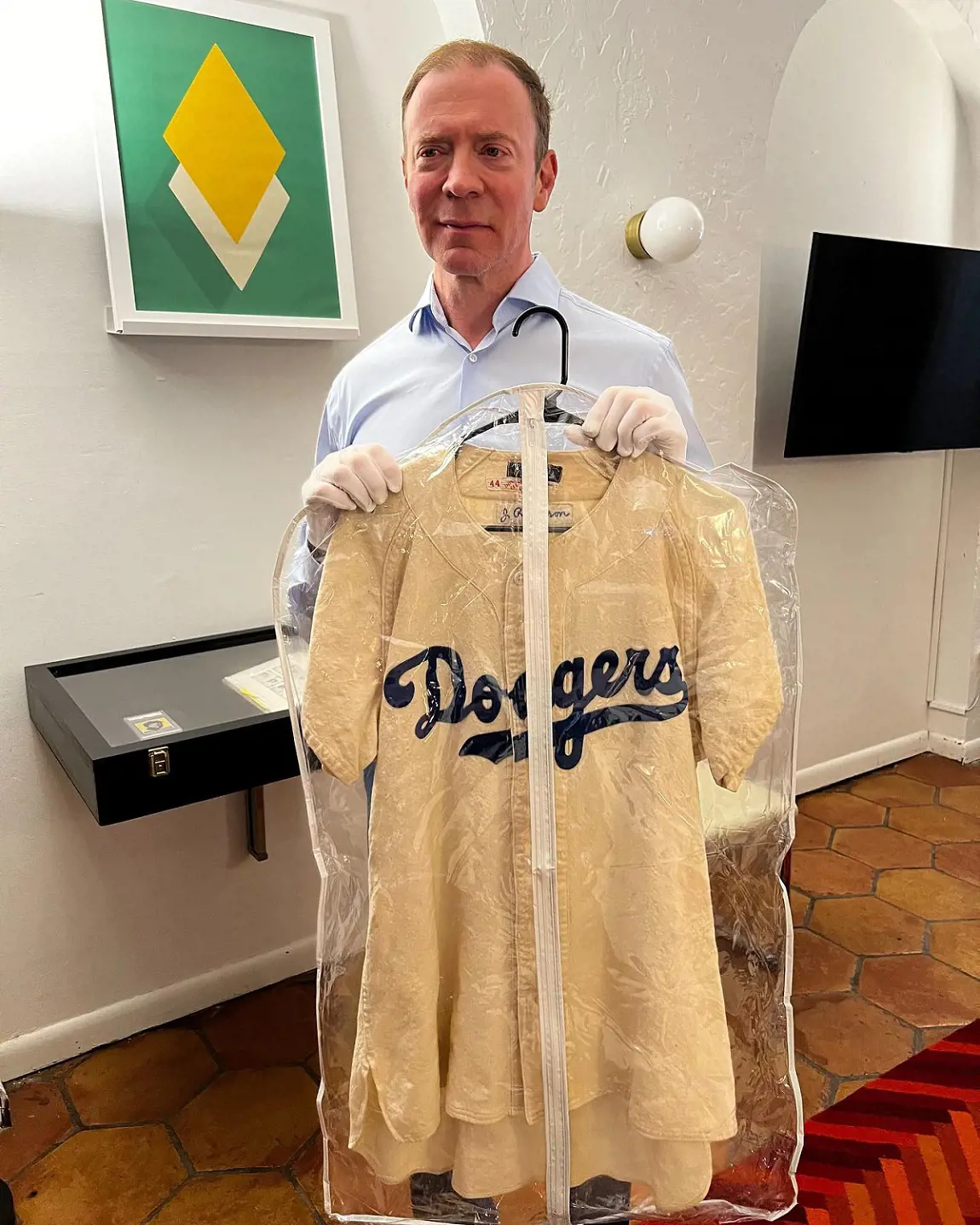 Ken displaying one-of-a-kind Jackie Robinson game-used jersey, his business took another elevation during the pandemic in 2020