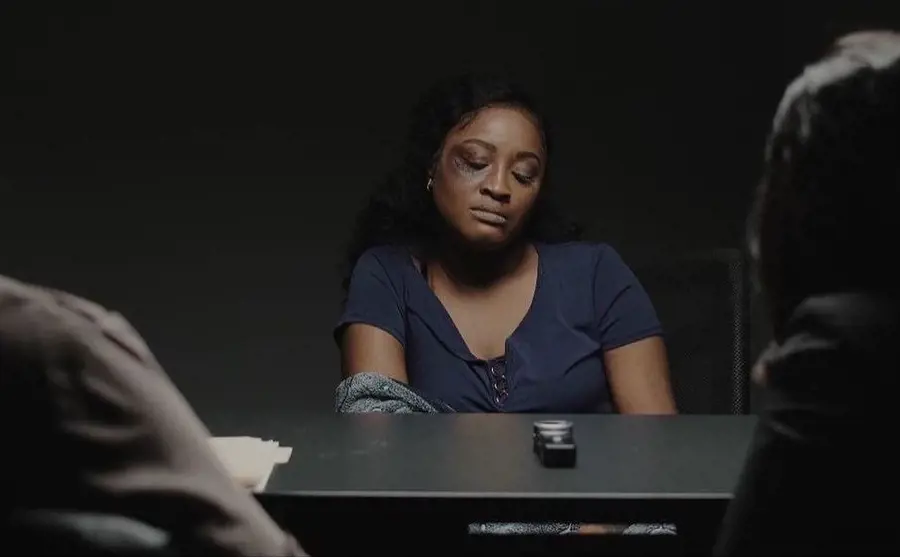 Kayla being interrogated by the detectives in one of the scene of the movie; she is abused by her husband